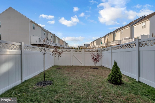 view of yard with a residential view and a fenced backyard