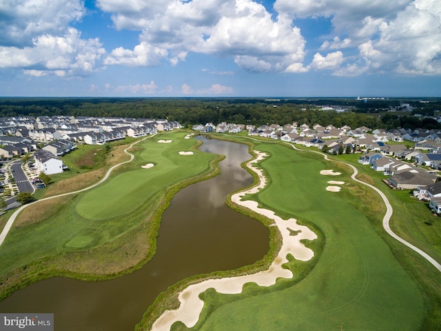 birds eye view of property with view of golf course, a water view, and a residential view