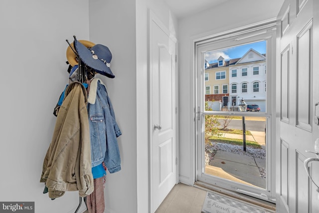 doorway to outside with light tile patterned floors