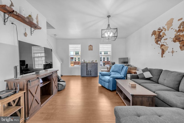 living room with light wood-style flooring and a chandelier