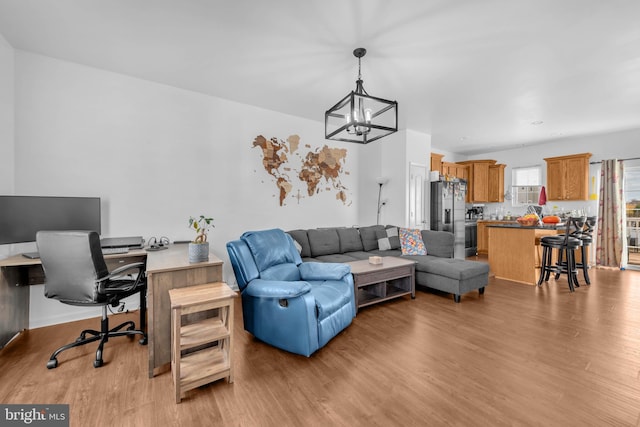 living room featuring a notable chandelier and light wood finished floors