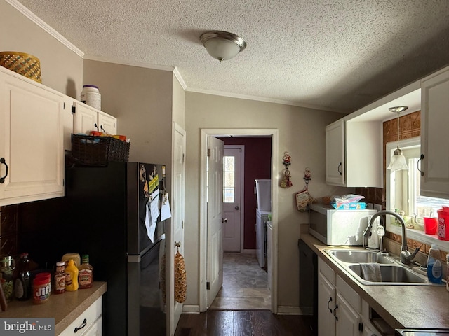 kitchen featuring a textured ceiling, sink, white cabinets, dark hardwood / wood-style floors, and stainless steel refrigerator