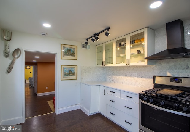 kitchen with gas range, white cabinetry, wall chimney exhaust hood, tasteful backsplash, and track lighting