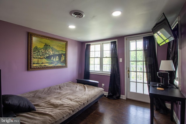 bedroom with dark wood-type flooring