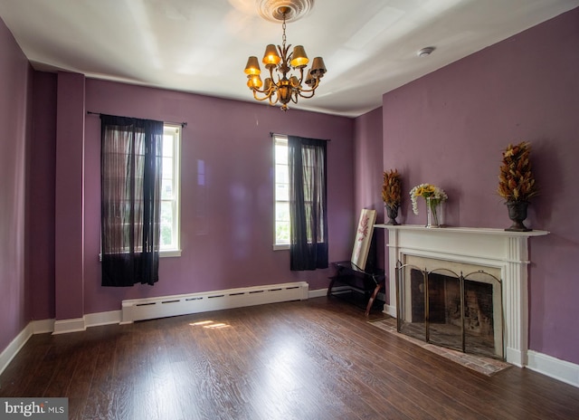 unfurnished living room with a chandelier, hardwood / wood-style flooring, and a baseboard heating unit