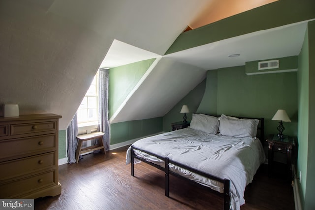 bedroom featuring lofted ceiling and dark wood-type flooring