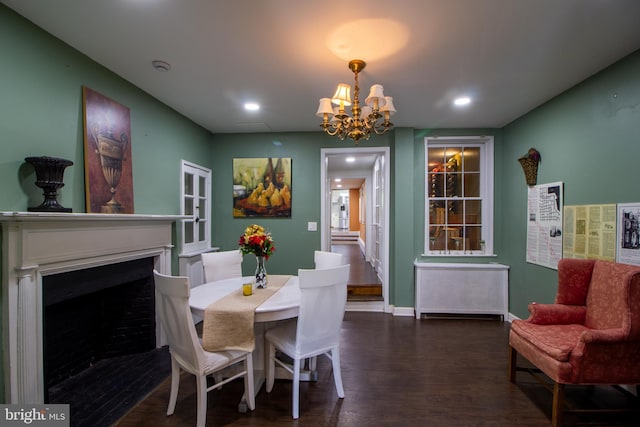 dining area with a chandelier and dark hardwood / wood-style floors