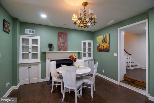 dining area featuring an inviting chandelier and dark wood-type flooring