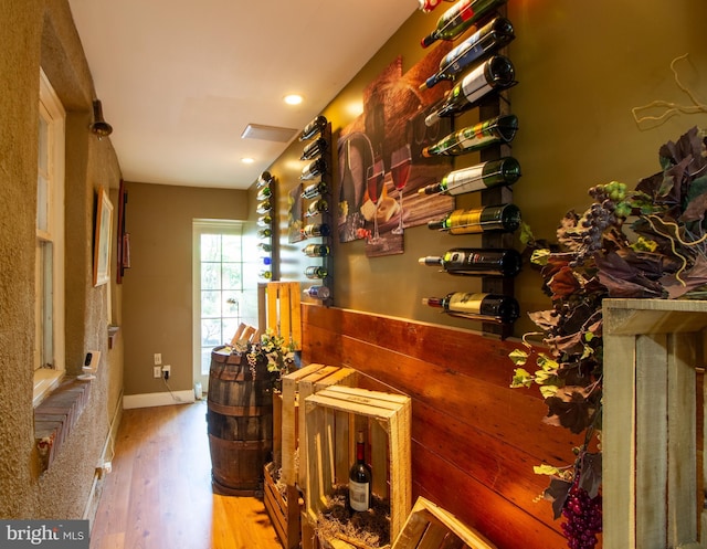 bar with light hardwood / wood-style floors