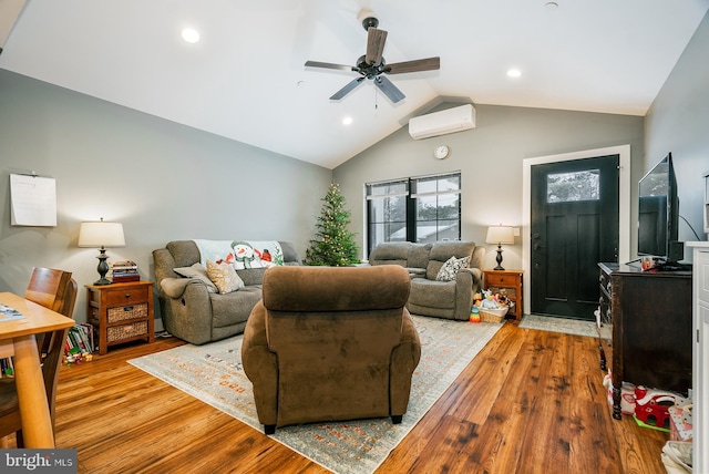 living room featuring a wall mounted air conditioner, ceiling fan, lofted ceiling, and light hardwood / wood-style flooring