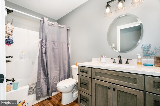 full bathroom with shower / tub combo with curtain, vanity, hardwood / wood-style floors, and toilet