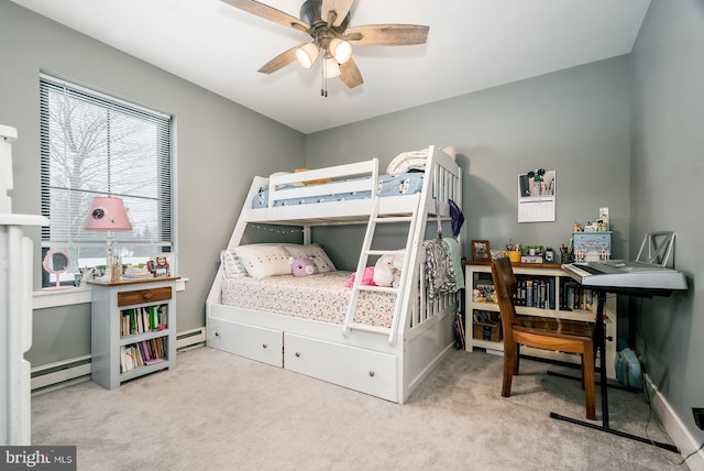 carpeted bedroom with baseboard heating and ceiling fan