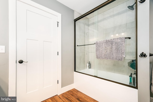 bathroom featuring shower / bath combination with glass door and wood-type flooring