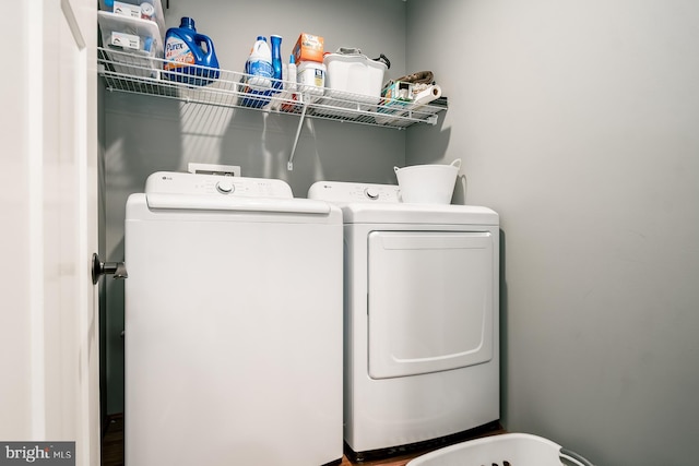 clothes washing area with washer and clothes dryer