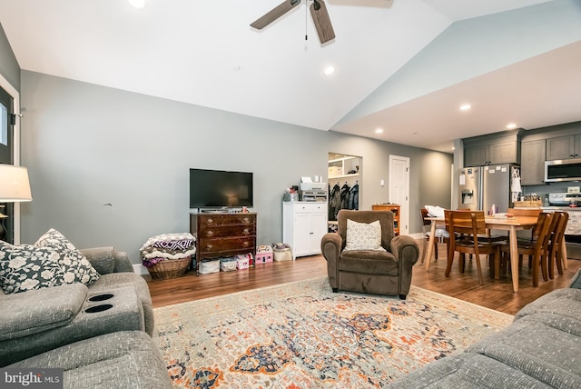 living room featuring ceiling fan, dark hardwood / wood-style flooring, and lofted ceiling