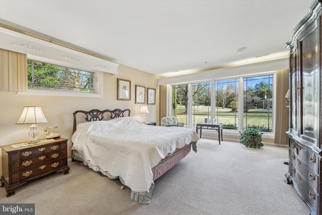 bedroom featuring light colored carpet