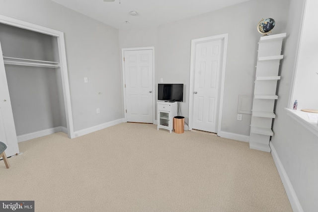 unfurnished bedroom featuring light carpet