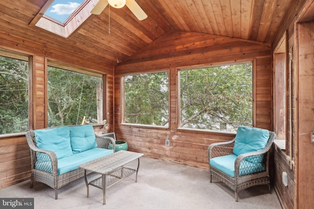 sunroom with ceiling fan, vaulted ceiling with skylight, and wooden ceiling