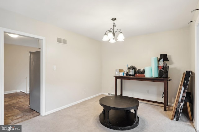 interior space featuring a chandelier and carpet