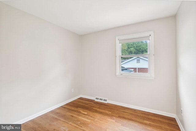 spare room featuring hardwood / wood-style floors