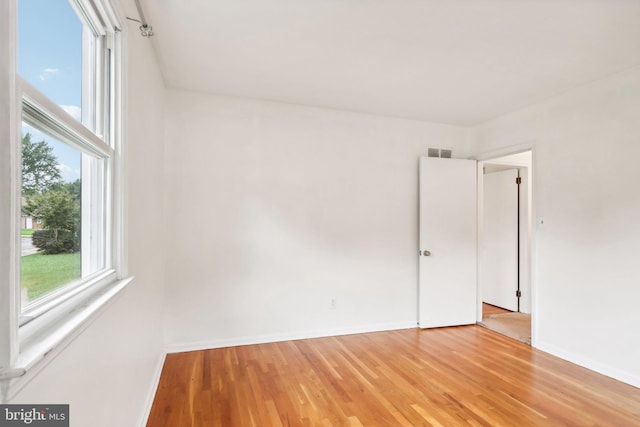 unfurnished room featuring hardwood / wood-style floors