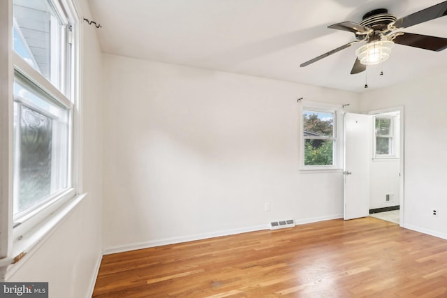 empty room featuring ceiling fan and light hardwood / wood-style flooring