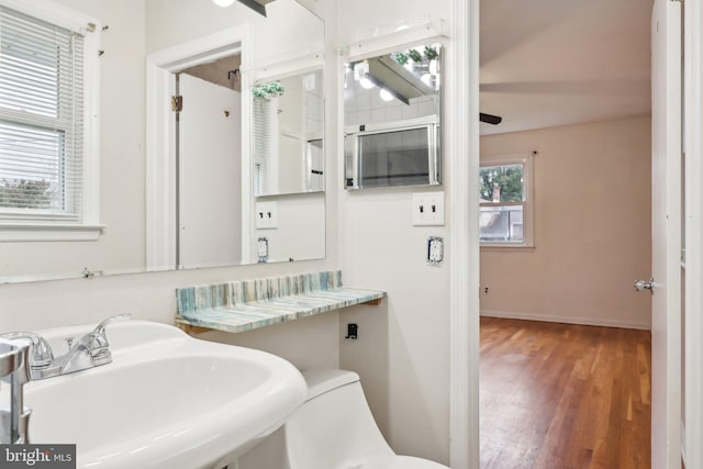 bathroom with hardwood / wood-style floors, ceiling fan, and sink