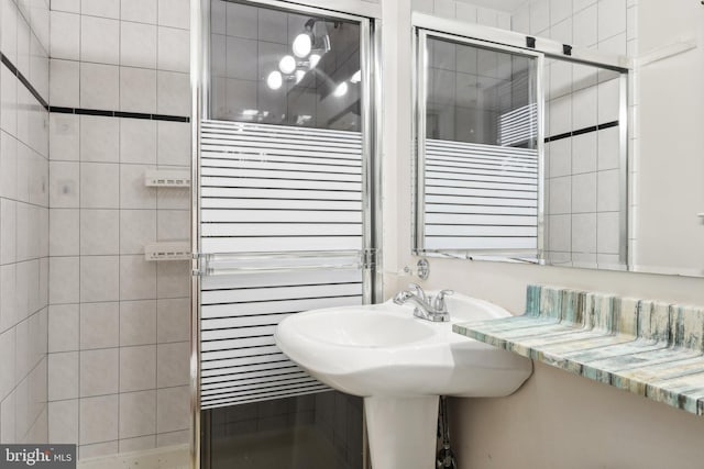 bathroom featuring radiator heating unit and an enclosed shower