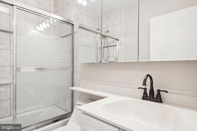 bathroom featuring vanity and combined bath / shower with glass door