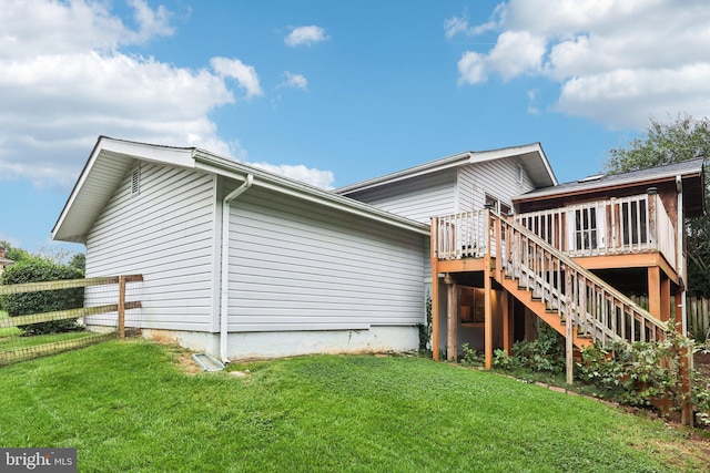 back of house featuring a yard and a wooden deck