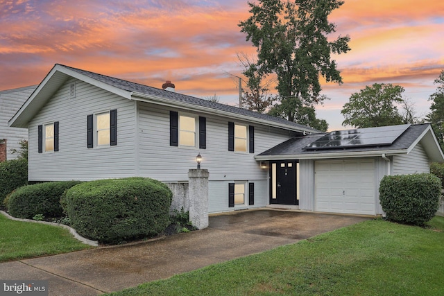 view of front of house with solar panels and a garage