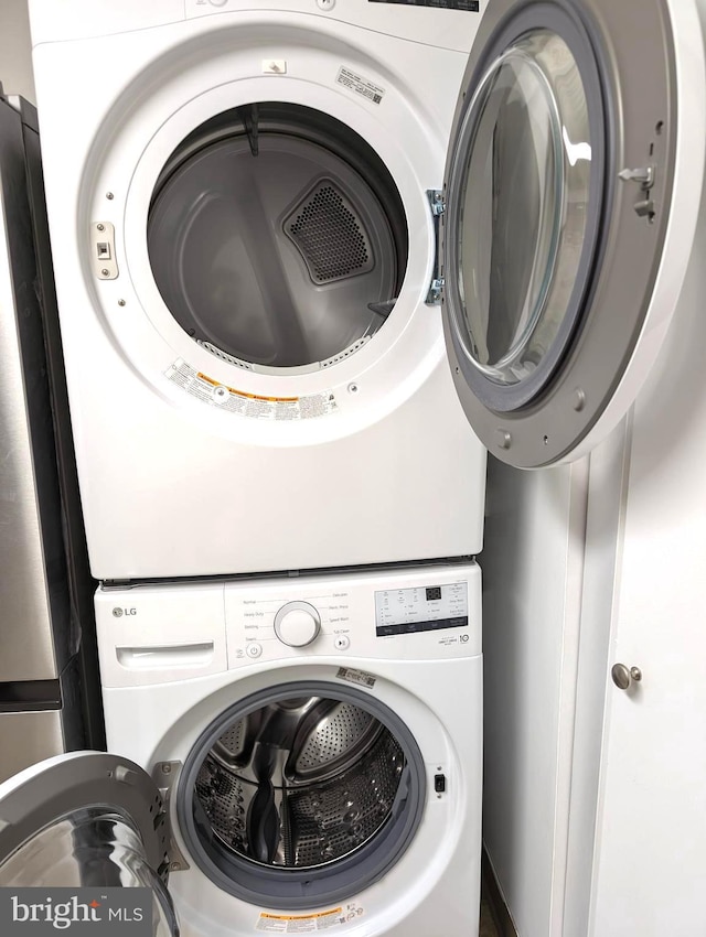 laundry area with stacked washer / dryer