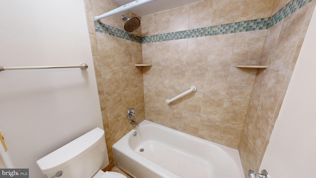 bathroom featuring tiled shower / bath combo and toilet