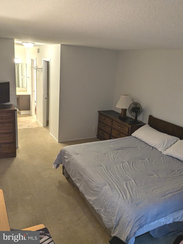 carpeted bedroom featuring ensuite bath, a textured ceiling, and pool table