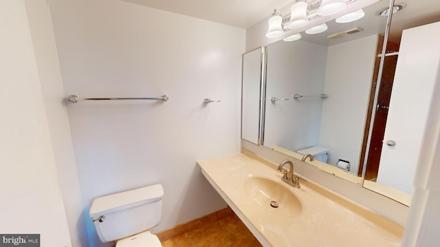 bathroom with sink, tile patterned flooring, and toilet