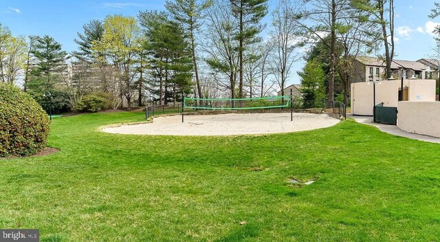 view of home's community featuring a lawn and volleyball court