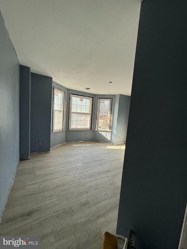 unfurnished room with light wood-type flooring