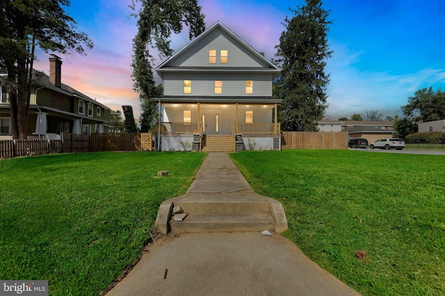 view of front facade featuring a porch and a yard