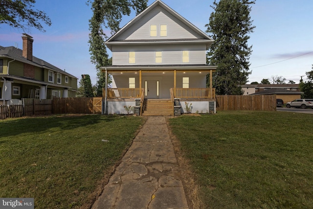 view of front of house with covered porch and a lawn