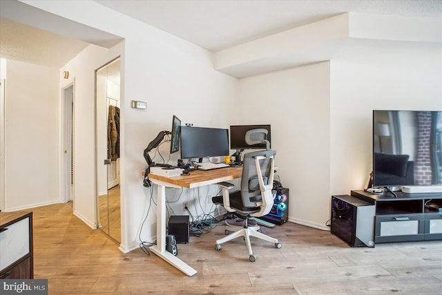 office with light hardwood / wood-style floors