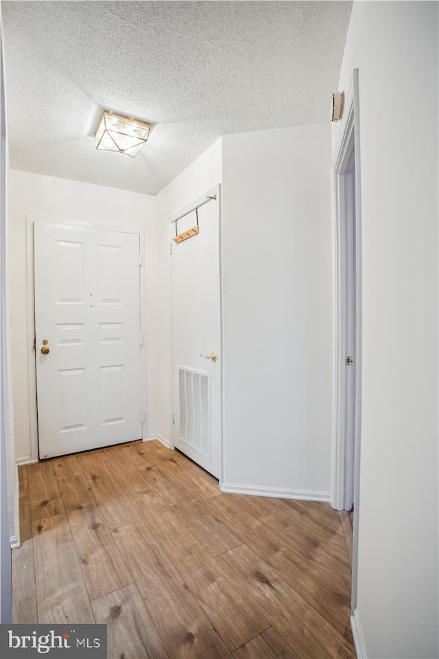 entryway featuring a textured ceiling and hardwood / wood-style floors