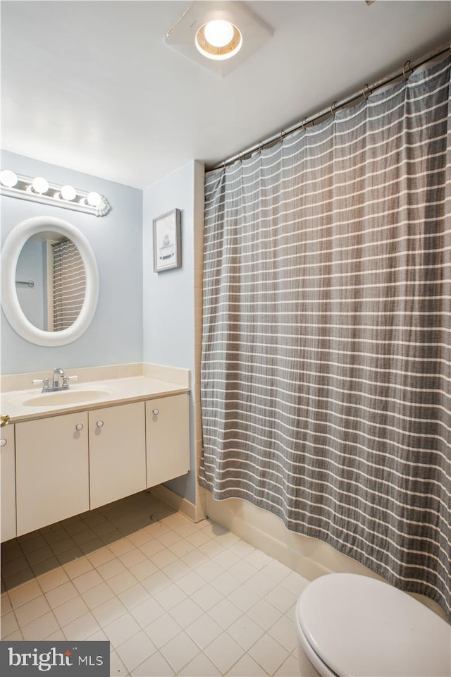 bathroom featuring toilet, vanity, and tile patterned flooring