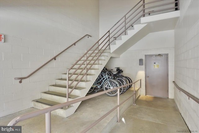 staircase with concrete floors