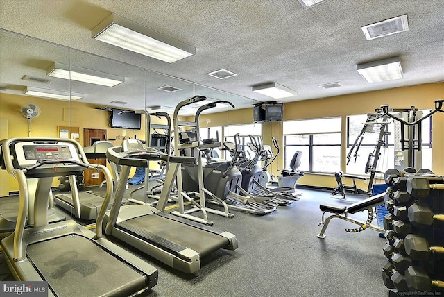 exercise room with a textured ceiling