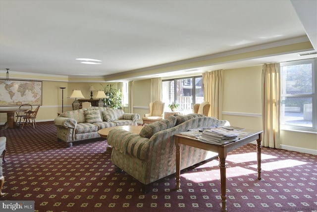 carpeted living room featuring crown molding