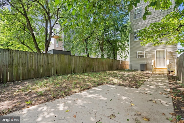 view of yard with central AC and a patio area