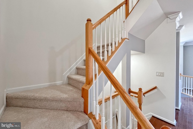 staircase with carpet flooring and lofted ceiling