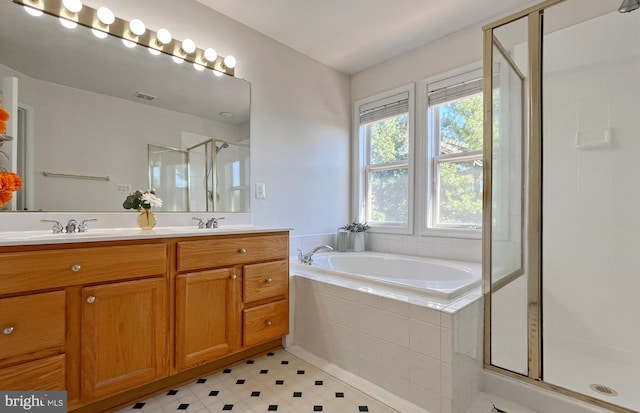 bathroom featuring vanity and shower with separate bathtub