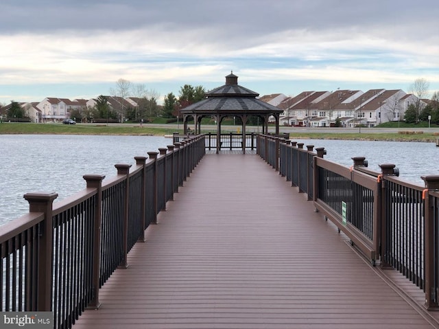 view of dock featuring a gazebo and a water view