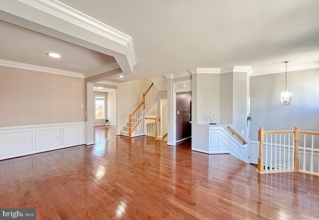 spare room with hardwood / wood-style flooring and crown molding